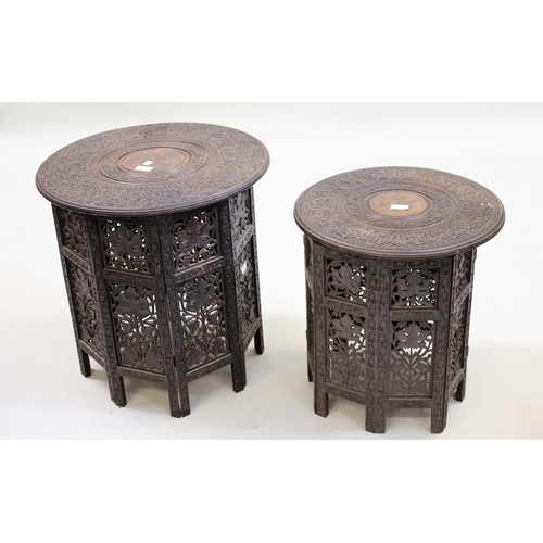 1442 - Two late 19th / early 20th Century Indian carved hardwood circular occasional tables with folding st... 