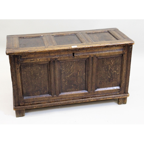 1446 - Small 17th Century oak coffer, the hinged three panel lid above a three panel front on stile support... 