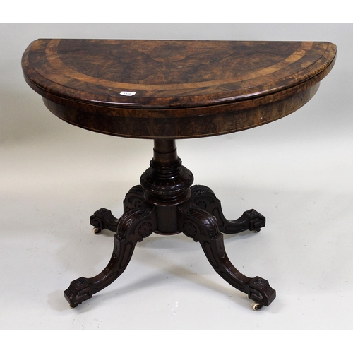 1458 - Victorian figured walnut half round fold-over card table, on turned column and four cabriole support... 