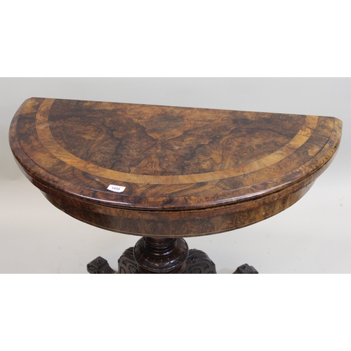 1458 - Victorian figured walnut half round fold-over card table, on turned column and four cabriole support... 