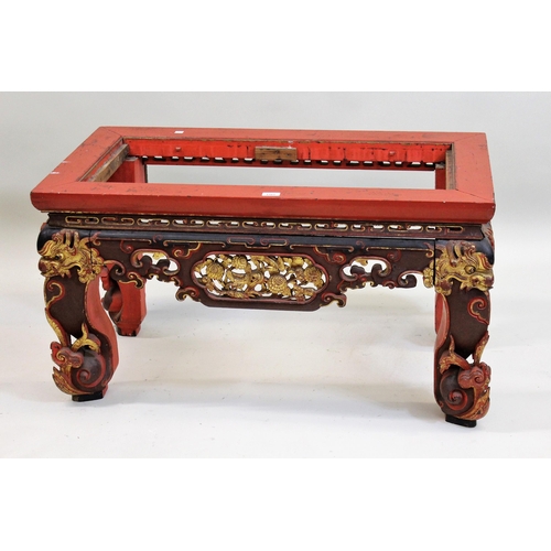 1501 - Chinese red and black lacquered and gilded low altar table, the carved frieze raised on carved suppo... 