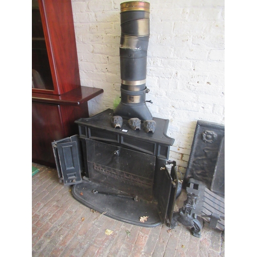 1521 - Large late 20th Century log burner with panelled front, and brass knob handles, 76cms high x 89cms w... 