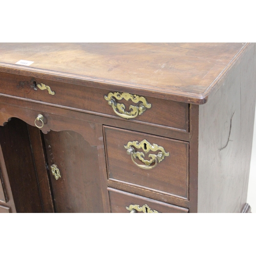 1553 - George III mahogany kneehole desk, the moulded top above a single long and six small drawers with cu... 