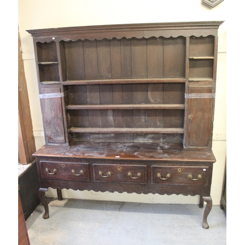 1555 - 18th Century oak dresser, the boarded shelf back with two cupboard doors, the base with three drawer... 