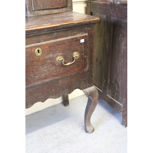 1555 - 18th Century oak dresser, the boarded shelf back with two cupboard doors, the base with three drawer... 