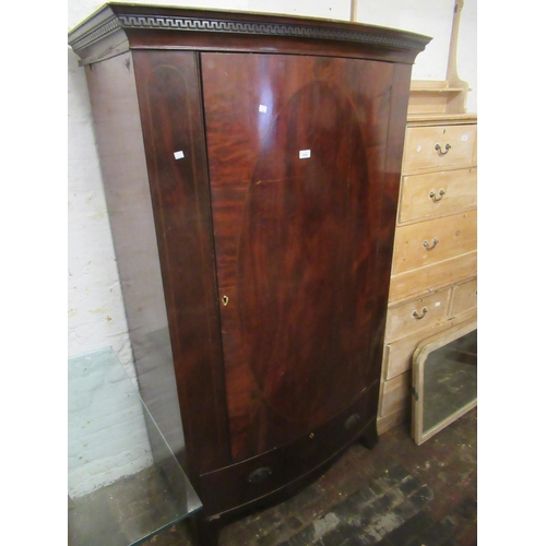 1559 - Small Edwardian mahogany bow fronted wardrobe with a moulded cornice, above a single line inlaid doo... 