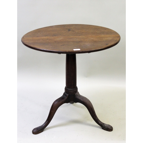 1565 - 18th Century circular oak tilt-top table, on turned column and tripod support, 68cms diameter