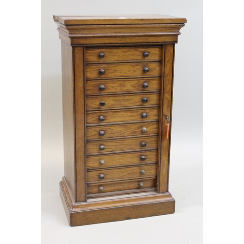 1566 - 19th Century oak Wellington type table chest of ten drawers, on a shaped moulded plinth base