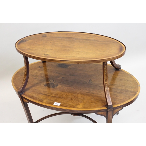 1586 - Edwardian rosewood, satinwood crossbanded and line inlaid two tier oval etagere, raised on splay sup... 