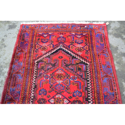 16 - Hamadan rug of all-over floral geometric design with multiple borders on a wine red ground, 218cms x... 