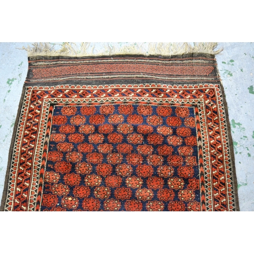 17 - Belouch rug with all-over medallion design with multiple borders on a midnight blue and red ground, ... 