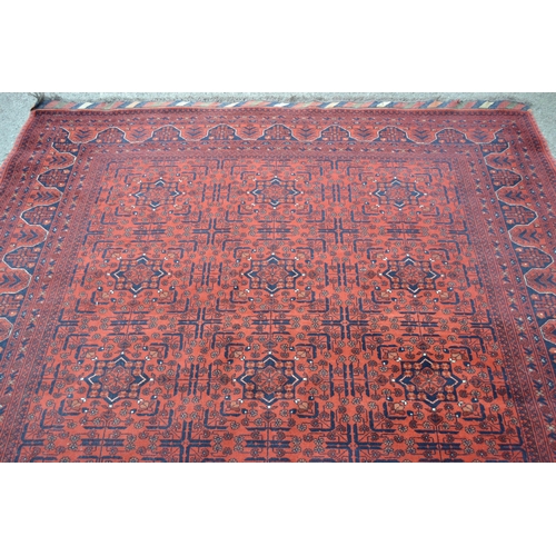 18 - Modern Afghan Belouch carpet with three rows of six gols on wine ground with borders, 300cms x 208cm... 