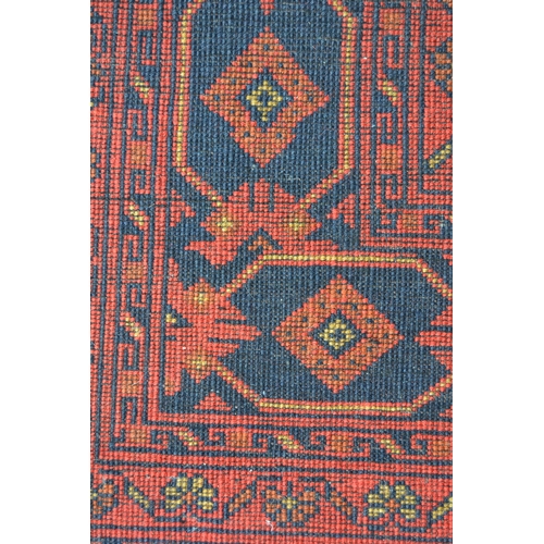 19 - Modern Afghan Belouch carpet with an all-over tile pattern design and multiple borders, 290cms x 196... 