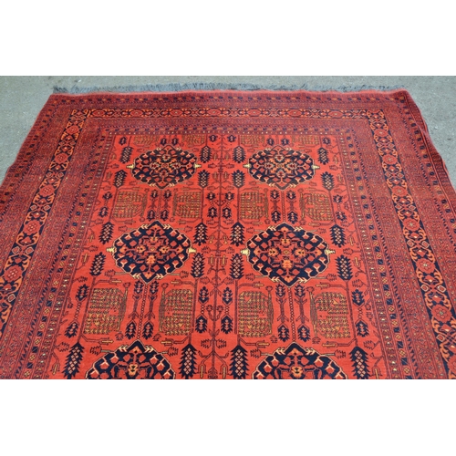 20 - Modern Afghan Belouch carpet with two rows of four gols and an all-over stylised floral design on a ... 