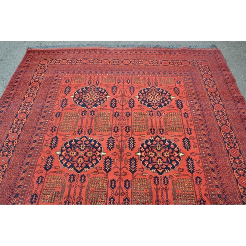 20 - Modern Afghan Belouch carpet with two rows of four gols and an all-over stylised floral design on a ... 