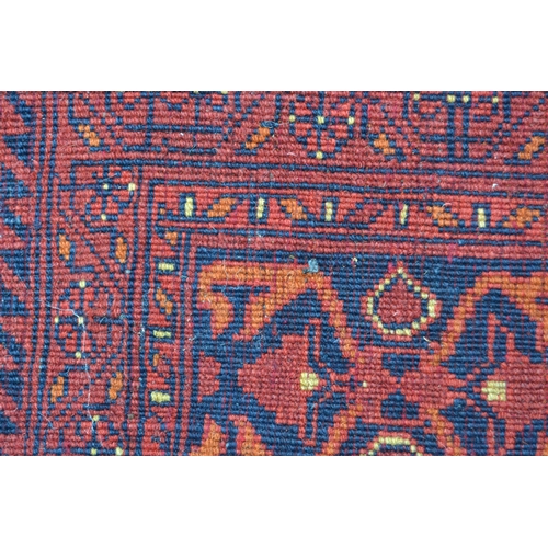 20 - Modern Afghan Belouch carpet with two rows of four gols and an all-over stylised floral design on a ... 