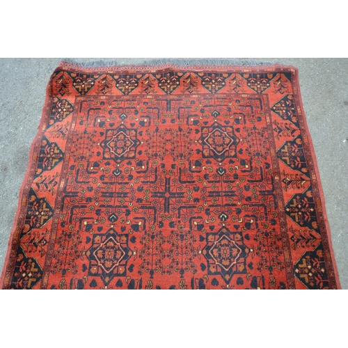 21 - Afghan Belouch rug with two rows of three gols on wine ground with borders, 193cms x 125cms approxim... 