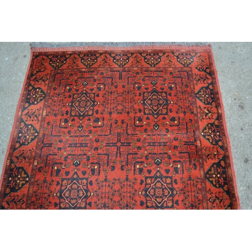 21 - Afghan Belouch rug with two rows of three gols on wine ground with borders, 193cms x 125cms approxim... 