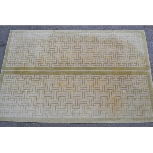 22 - Modern Tibetan carpet with a two panel Key pattern design in shades of beige and pale green (some st... 