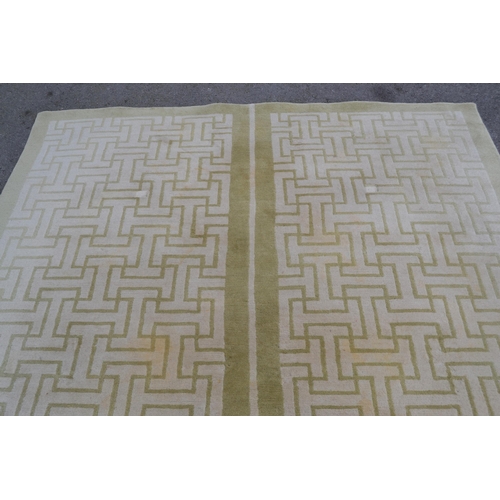 22 - Modern Tibetan carpet with a two panel Key pattern design in shades of beige and pale green (some st... 