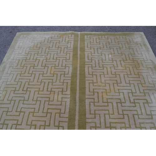 22 - Modern Tibetan carpet with a two panel Key pattern design in shades of beige and pale green (some st... 