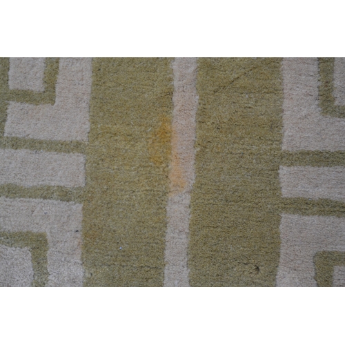 22 - Modern Tibetan carpet with a two panel Key pattern design in shades of beige and pale green (some st... 