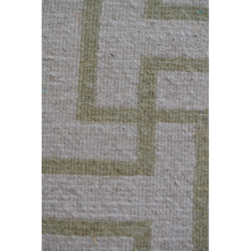 22 - Modern Tibetan carpet with a two panel Key pattern design in shades of beige and pale green (some st... 