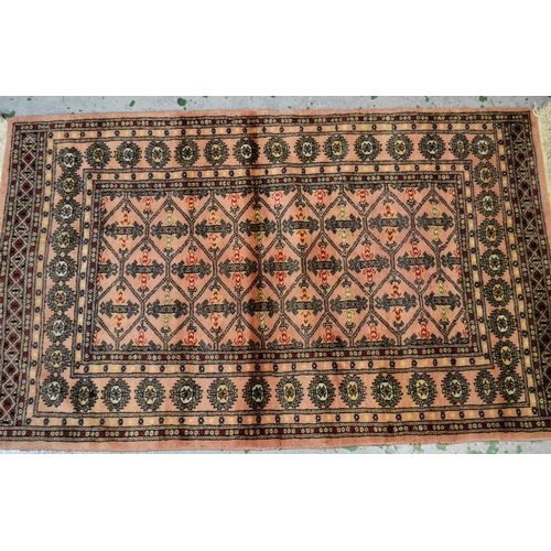 23 - Pakistan rug of Turkoman design with pink ground, 161cms x 100cms