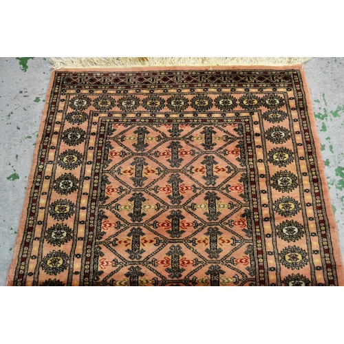 23 - Pakistan rug of Turkoman design with pink ground, 161cms x 100cms