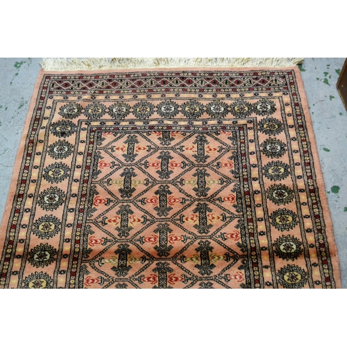 23 - Pakistan rug of Turkoman design with pink ground, 161cms x 100cms