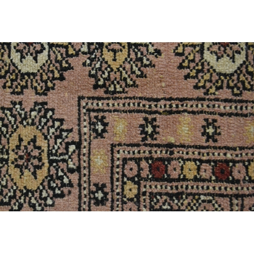 23 - Pakistan rug of Turkoman design with pink ground, 161cms x 100cms