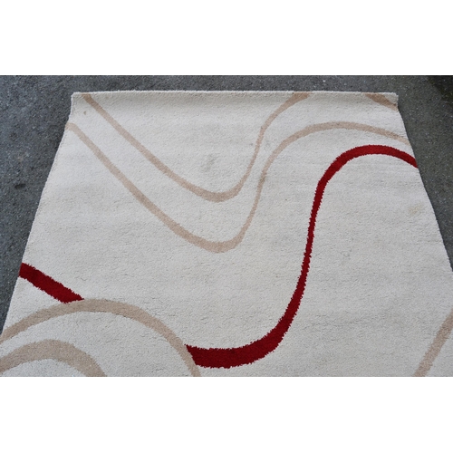 24 - Modern machine woven rug of Art Deco design in shades of beige and red, 232cms x 160cms, together wi... 