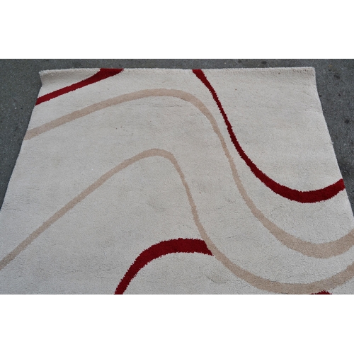 24 - Modern machine woven rug of Art Deco design in shades of beige and red, 232cms x 160cms, together wi... 