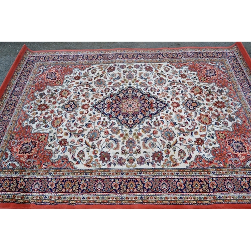 25 - Machine woven rug of Persian design in shades of cream and pink, 231cms x 169cms