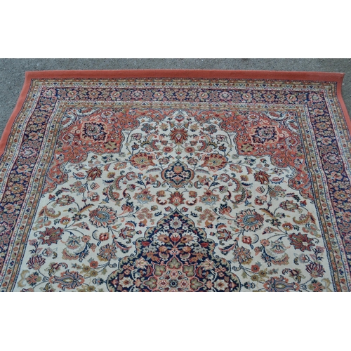 25 - Machine woven rug of Persian design in shades of cream and pink, 231cms x 169cms