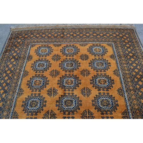 27 - Afghan gold ground carpet with three rows of eight gols within a multiple border, 290cms x 210cms