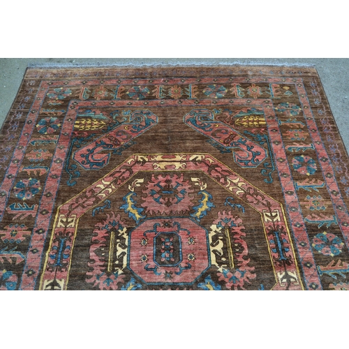 28 - Bastan carpet with a medallion and stylised floral design on a fawn ground, in shades of rose, blue,... 