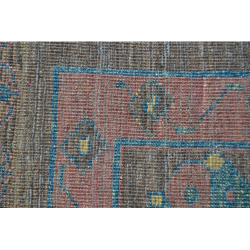 28 - Bastan carpet with a medallion and stylised floral design on a fawn ground, in shades of rose, blue,... 