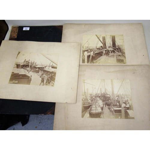 294 - Album containing three large format photographs, scenes onboard a ship, cable laying and buoy laying... 