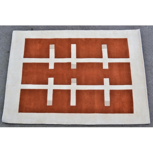 30 - Modern machine woven rug of Art Deco design in shades of rust, cream and beige, 240cms x 170cms