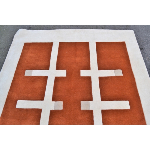 30 - Modern machine woven rug of Art Deco design in shades of rust, cream and beige, 240cms x 170cms