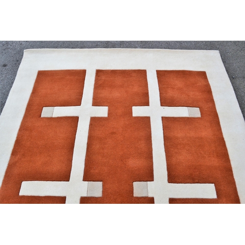 30 - Modern machine woven rug of Art Deco design in shades of rust, cream and beige, 240cms x 170cms