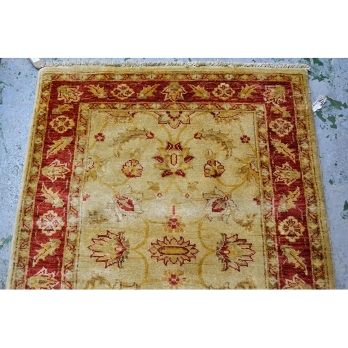 33 - Indo Persian runner with stylised floral design on an ivory ground with red ground borders, 290cms x... 