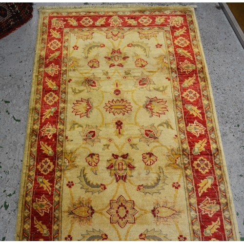 33 - Indo Persian runner with stylised floral design on an ivory ground with red ground borders, 290cms x... 