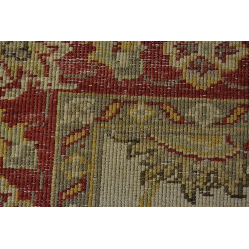 33 - Indo Persian runner with stylised floral design on an ivory ground with red ground borders, 290cms x... 