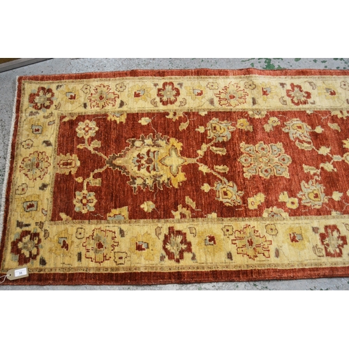 35 - Modern Afghan Ziegler design runner with a palmette and floral pattern on a rust ground with ivory b... 