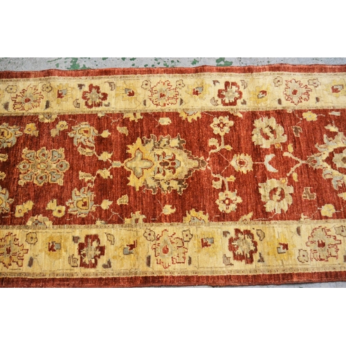 35 - Modern Afghan Ziegler design runner with a palmette and floral pattern on a rust ground with ivory b... 