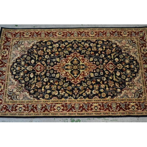 37 - Small Pakistan rug of Persian design with a medallion and floral all-over pattern on a navy ground w... 