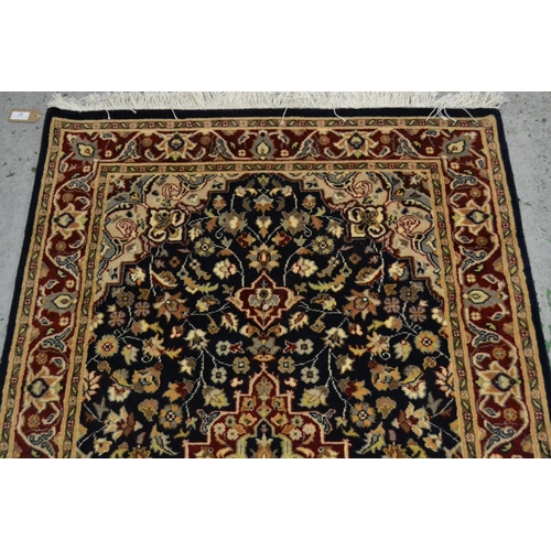 37 - Small Pakistan rug of Persian design with a medallion and floral all-over pattern on a navy ground w... 