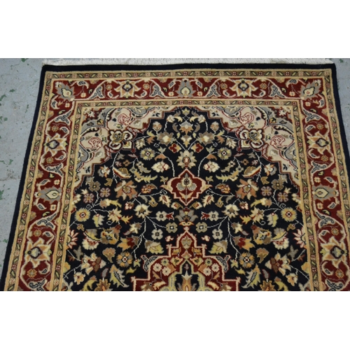 37 - Small Pakistan rug of Persian design with a medallion and floral all-over pattern on a navy ground w... 